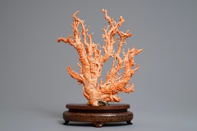 A Chinese carved red coral 'blossom tree' group on inlaid wooden stand, 19/20th C.